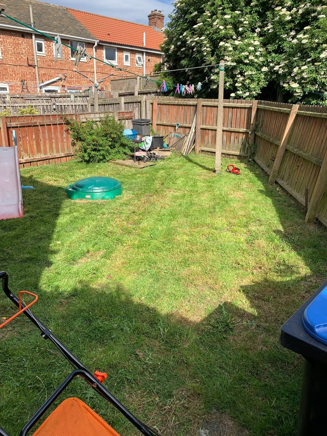 A long, neatly trimmed hedge around a freshly cut lawn in Park End
